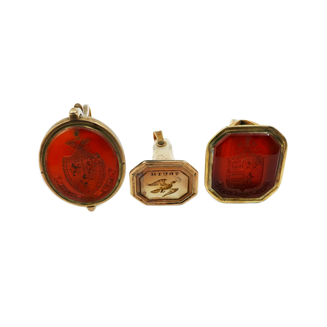 Two 19th century gold overlaid and carnelian set fob seals, both matrix carved with armorials, together with a similar gold and agate set fob seal